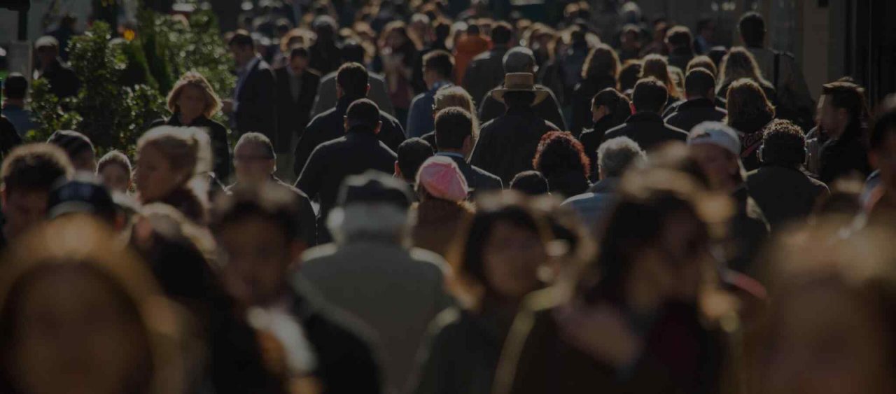 A bustling crowd of people in a busy urban area